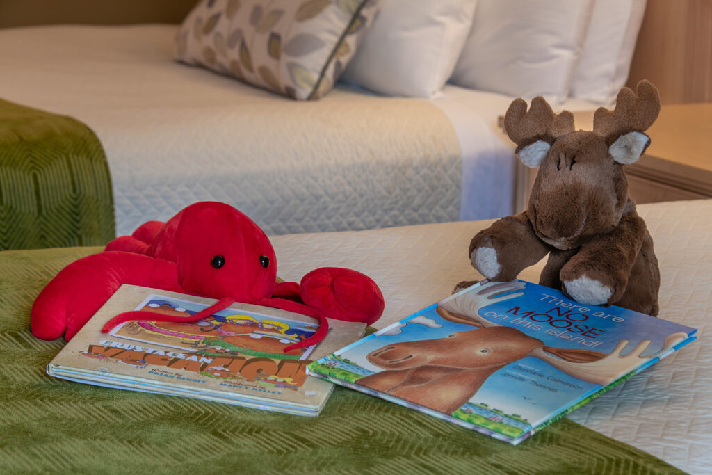 Photo of the stuffed moose,lobster towel and book included in the Kid's Package at the Acadia Inn, Bar Harbor, Maine