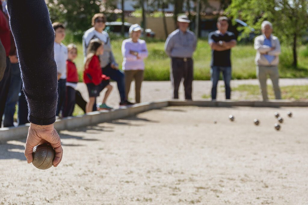 photo of people prepared to throw the boules ball in backyard of Acadia Inn