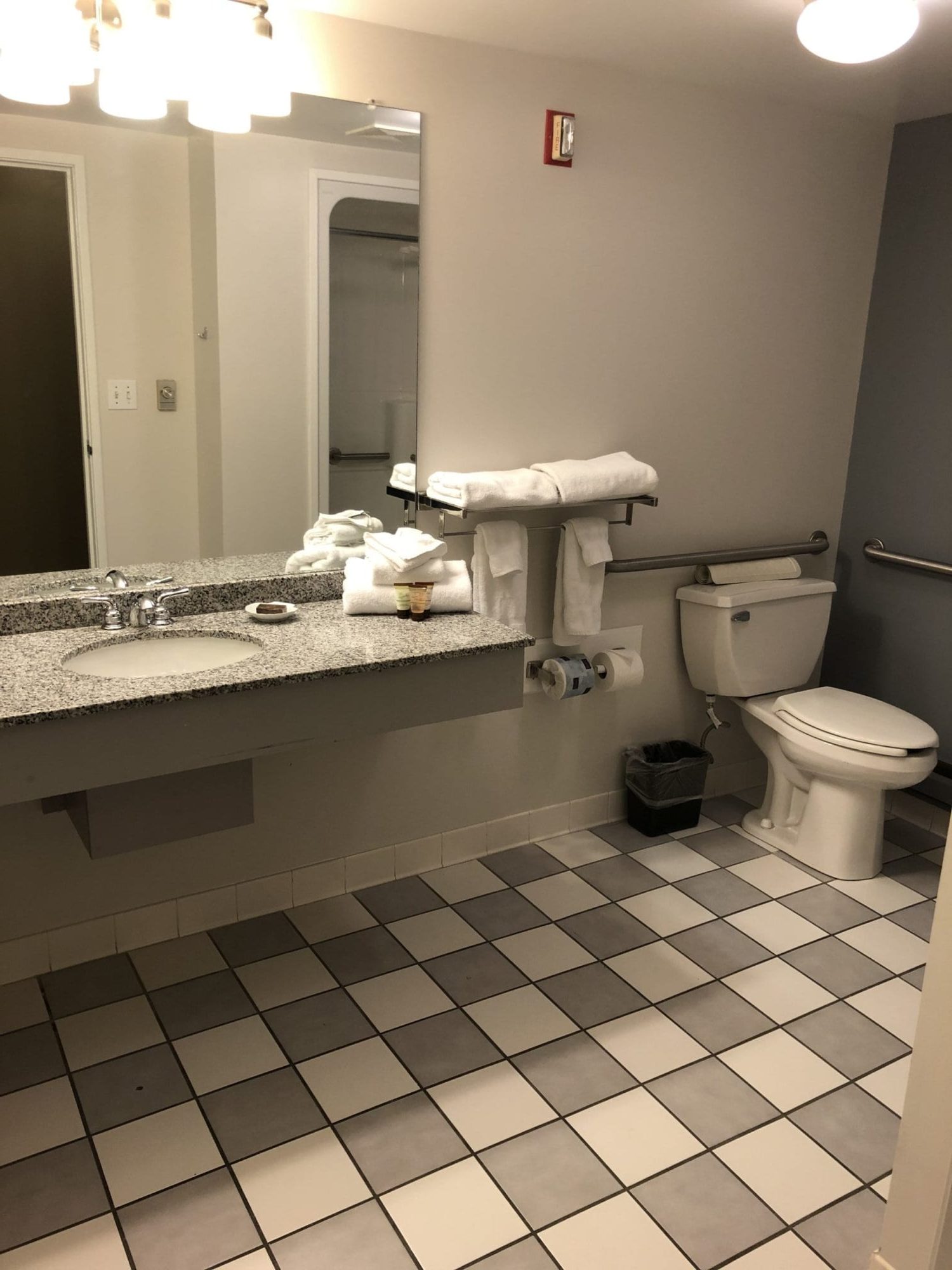 Photo of the bathroom of the Accessible King room with roll-in shower at the Acadia Inn.