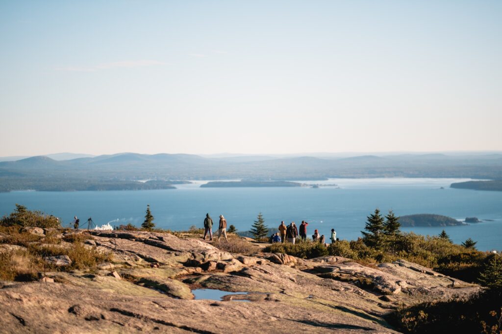 People enjoying water views at the top of Cadillac Mountain at Acadia National Park